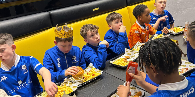 Youth football team players eating at Wing Kingz